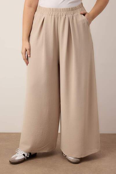 Trendyol Curve Beigefarbene Webhose mit weitem Bein TBBSS22PL00002