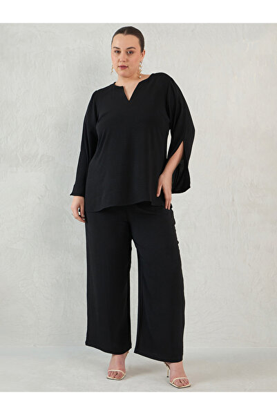 Femmella By Styli طقم بلوزة وبنطلون بأكمام شق الأسود بمقاسات كبيرة