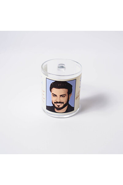 Story of candle A clear glass cup with "Majid Al Mohandes with two of his best songs"