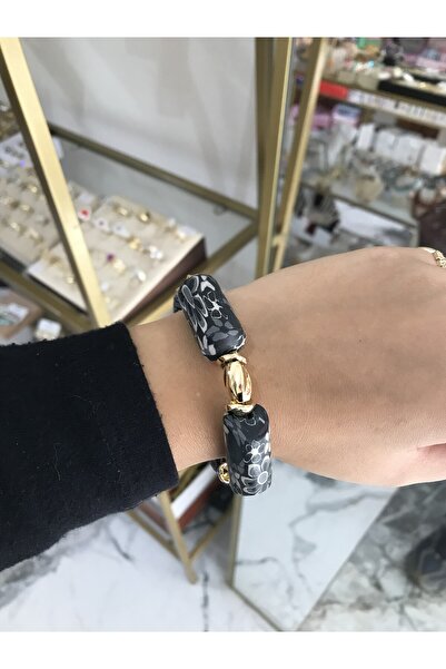 the ASEL İNCİ سوار مرن مفصل باللونين الأسود والذهبي