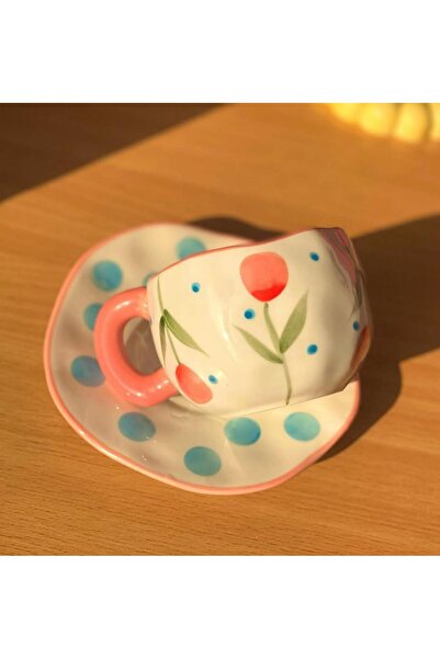 WarD Cup and saucer from Koythin porcelain featuring an elegant floral design.