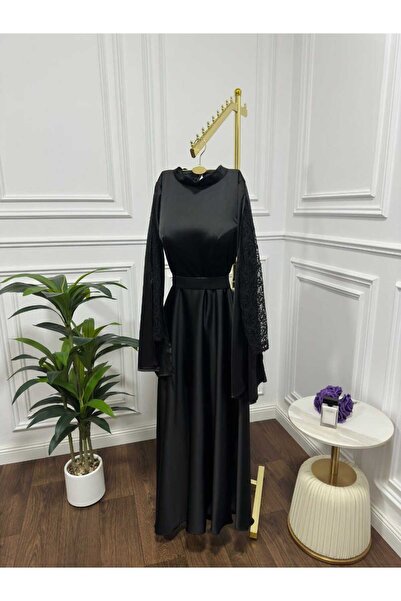 Riva Elegant long black dress with wide, sheer lace sleeves.