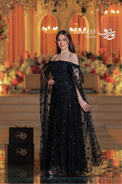 WAREEF FASHION Long black off-shoulder evening dress embroidered with sequins and sheer tulle sleeves