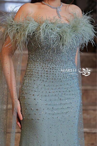 WAREEF FASHION Tiffany-colored evening dress with feathers
