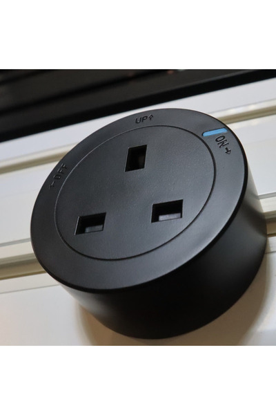 PARL A movable electrical socket designed for use with a Power Track system. It is flexible.