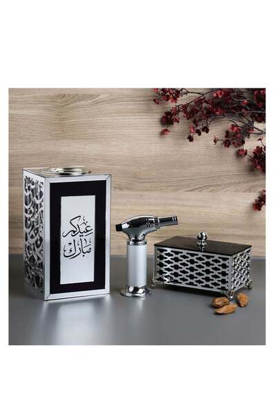 Story of candle An incense burner with a box for storing incense, bearing the phrase "Eid Mubarak," along with Maroki oud and a luxury lighter.