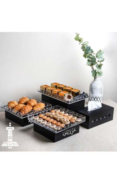 Story of candle A set of black buffet tables with an Arabic inscription, measuring 33x21x13 cm.