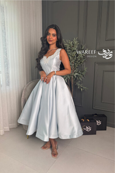 WAREEF FASHION A soft, sky-blue dress adorned with sequins