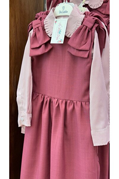 La reina petite Pink elementary school uniform with a striped shirt and bows on the shoulder