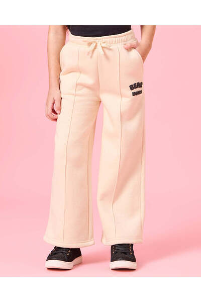 REDTAG بنطلون رياضي أرجل واسعة بطبعة عناق الدب باللون البيج للبنات