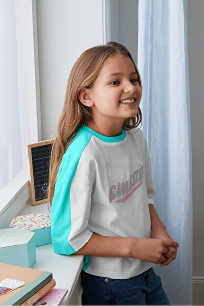 Tchibo بلوزة مطبوعة برسومات بأكمام قصيرة وياقة دائرية للفتيات الصغيرات، لون أبيض