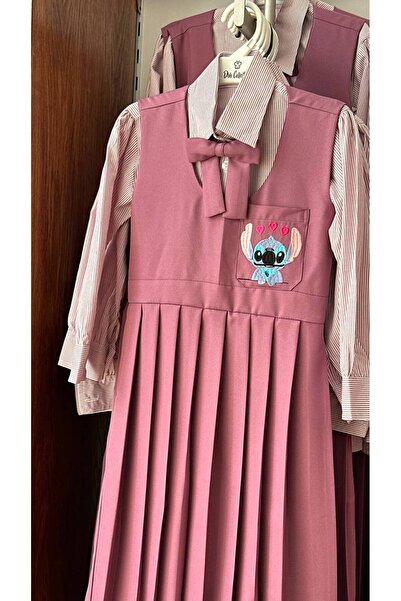 La reina petite Larina Petit purple elementary school pinafore embroidered with Stitch character, with a striped shirt and bow tie.