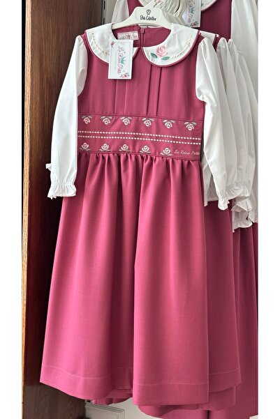 La reina petite Larina Petite pink primary school pinafore with attached embroidery at the waist and collar