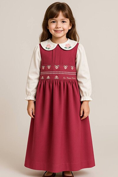 La reina petite Larina Petite pink primary school pinafore with attached embroidery at the waist and collar