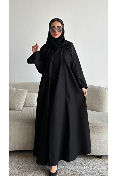 outline Luxurious black abaya embroidered with pearls in a connected dress design