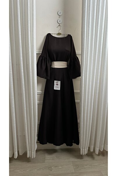 Onila Naham dress with long sleeves and a white belt
