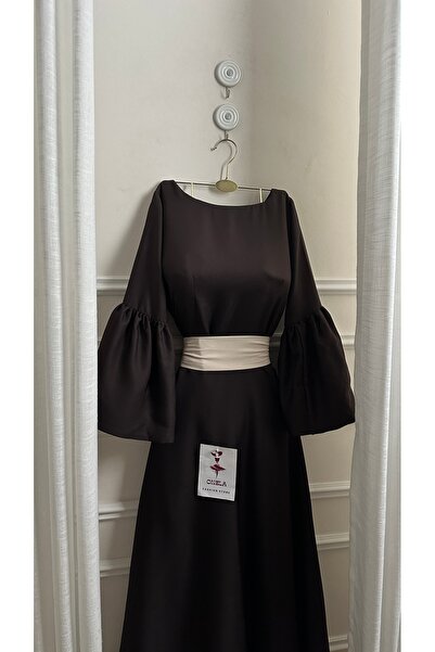 Onila Naham dress with long sleeves and a white belt