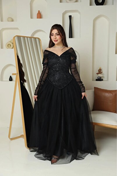 Nice Model Elegant black off-the-shoulder evening dress with a sequined bodice and sheer sleeves