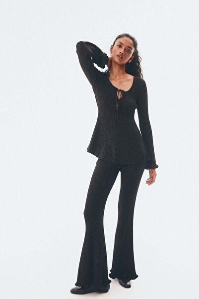 H&M بلوزة لامعة محبوكة