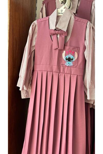 La reina petite Larina Petit purple elementary school pinafore embroidered with Stitch character, with a striped shirt and bow tie.