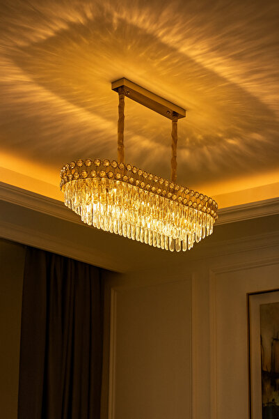 qwell A rectangular, gold-plated chandelier studded with crystals, suitable for living rooms.