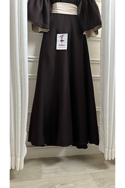 Onila Naham dress with long sleeves and a white belt