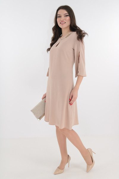Vanessa Line RO Elegant beige dress with cutout and gold accessory at the neckline