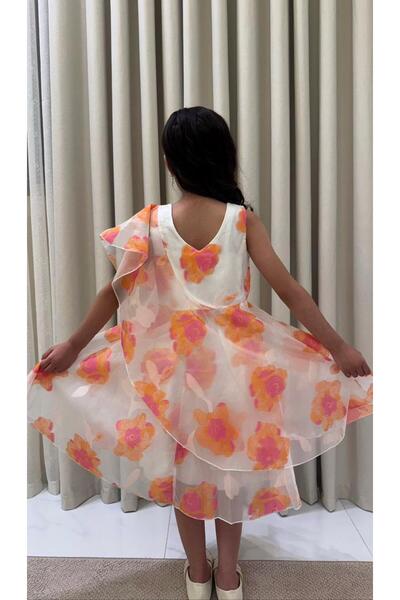 Generic A girl's dress with Draped layers, decorated with a bright floral print.