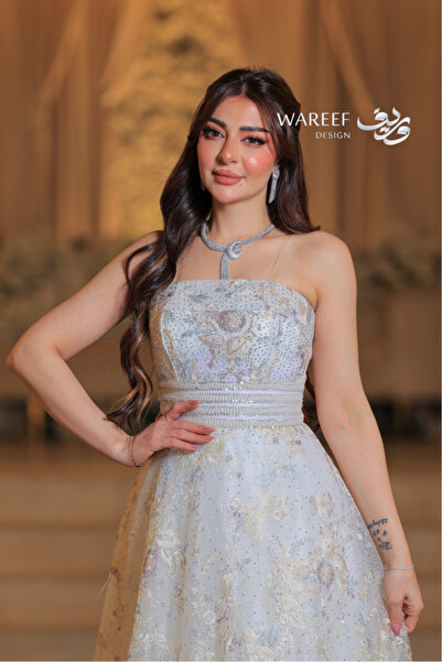 WAREEF FASHION Long beige sleeveless dress with floral beading and an A-line silhouette