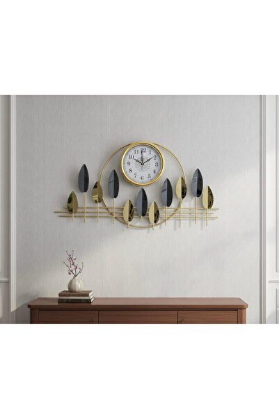 Noor A gold-colored metal wall clock with an elegant design featuring silver and gold leaf shapes, measuring 95*50