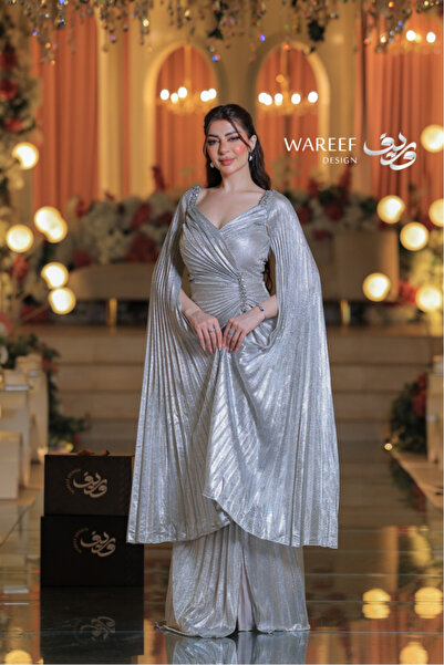 MAC CENTER A shimmering silver evening dress with long sleeves and a dramatic design.