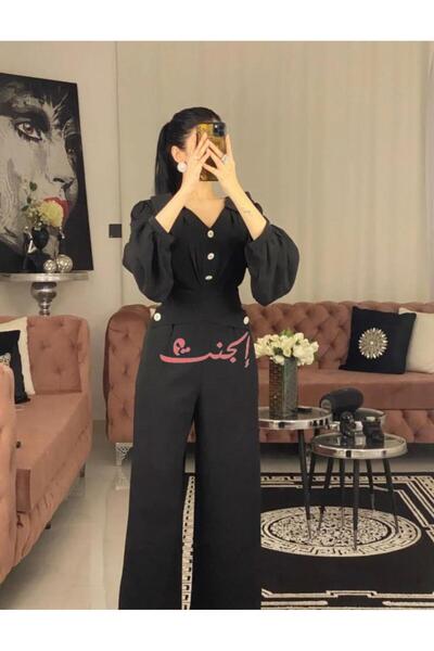 Elegent Elegant black jumpsuit with gold buttons and a puffy-sleeve design ideal for evenings and occasions.