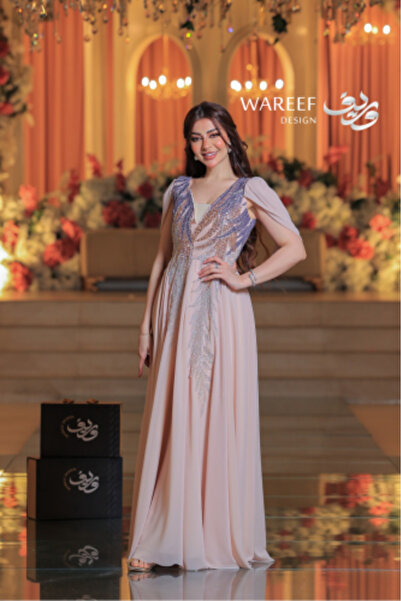 MAC CENTER Long, flesh-toned evening gown with a luxurious, hand-embroidered cape featuring multi-colored shimmering threads.