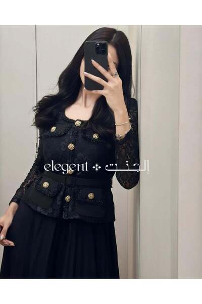 Elegent formal black dress with pleated lace, long sleeves, and gold buttons.