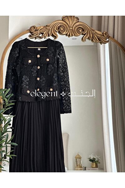 Elegent formal black dress with pleated lace, long sleeves, and gold buttons.