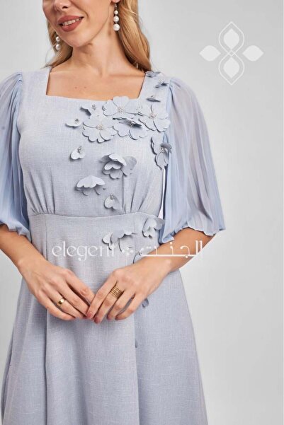 Elegent Sky blue dress adorned with 3D flowers and cape sleeves