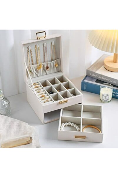 bity thok An ivory-colored jewelry box with an elegant, multi-layered design.