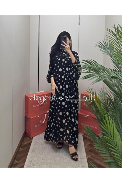 Elegent A black and white polka-dot dress with wide sleeves and modern elegance.