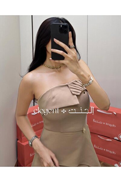 Elegent A soft beige off-the-shoulder dress with elegant pleats and an asymmetrical hemline.