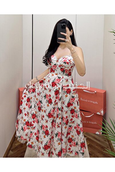 Elegent A soft, floral-print dress with a delicate pink pattern and thin straps.