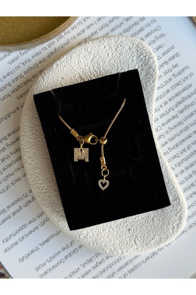 Rossetto Atelier قلادة من الفولاذ المقاوم للصدأ على شكل حرف M مع قلب لوسو