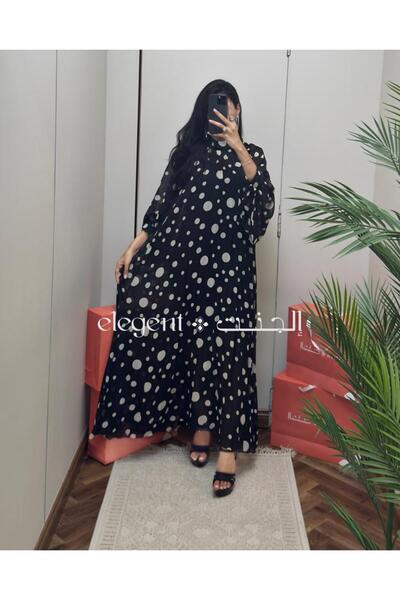 Elegent A black and white polka-dot dress with wide sleeves and modern elegance.