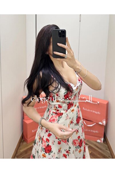 Elegent A soft, floral-print dress with a delicate pink pattern and thin straps.