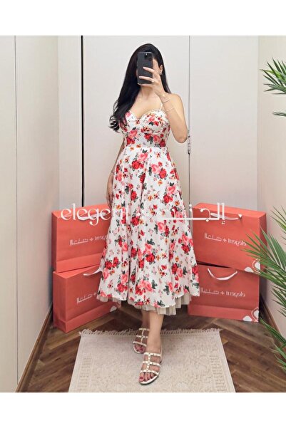 Elegent A soft, floral-print dress with a delicate pink pattern and thin straps.