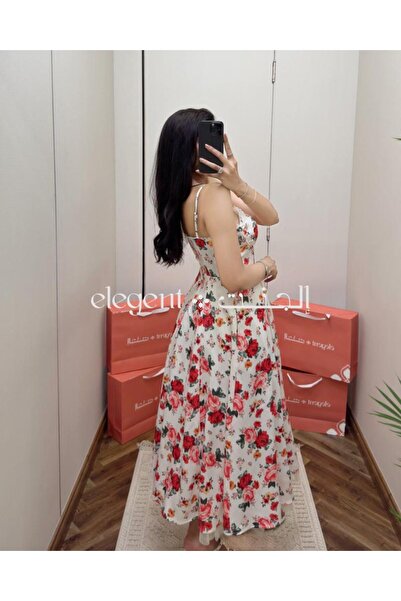 Elegent A soft, floral-print dress with a delicate pink pattern and thin straps.