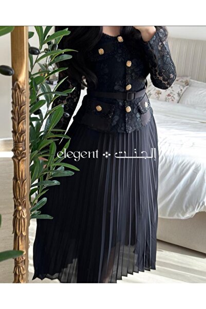 Elegent formal black dress with pleated lace, long sleeves, and gold buttons.