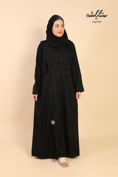 Stylish A Kuwaiti wrap abaya decorated with beading.