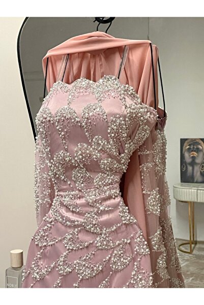 MANGONA A blush pink dress embellished with pearls, featuring a satin lining and cape sleeves, perfect for elegant bridal occasions.