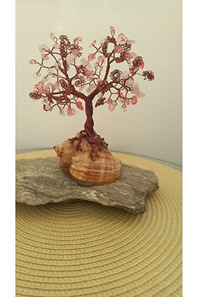Cristaltree Decorative tree made of rose quartz crystals and cherry quartz on a sea snail