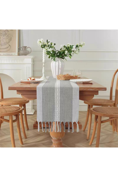 bity thok A luxurious gray dining tablecloth with a modern design and interlocking wicker edges.
